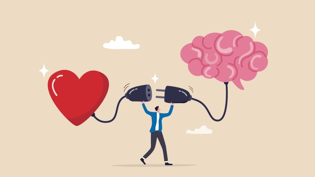 Illustration of a person holding two plugs, one connected to a heart and the other to a brain, symbolizing the connection between emotions and intellect. The background is light with clouds.