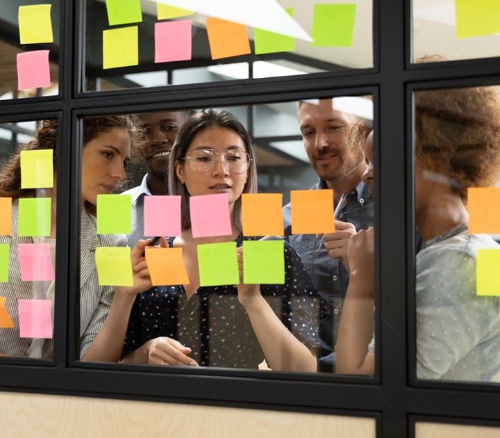 people brainstorming on sticky notes