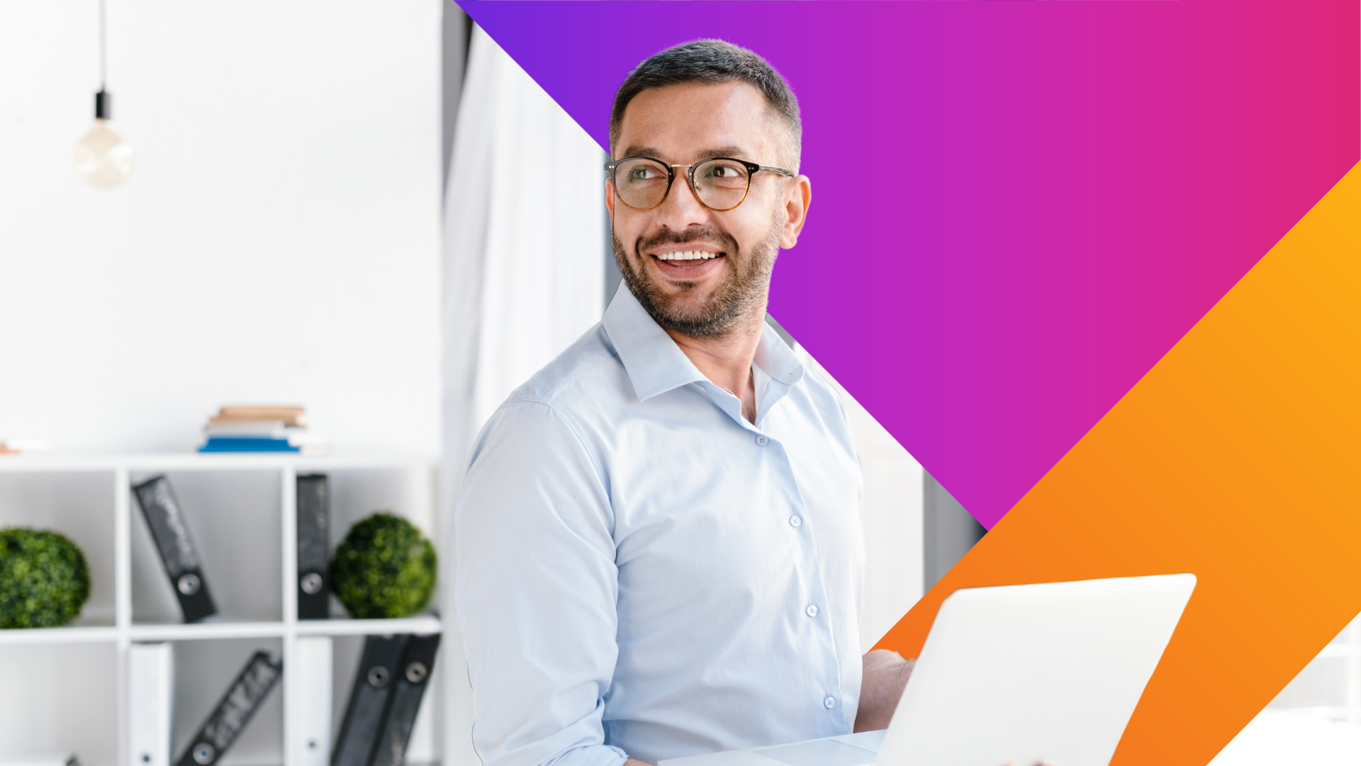 A smiling man with glasses holds a laptop in a bright office, with colorful purple and orange geometric shapes overlaid in the background. Shelves with books and green plants are visible behind him.