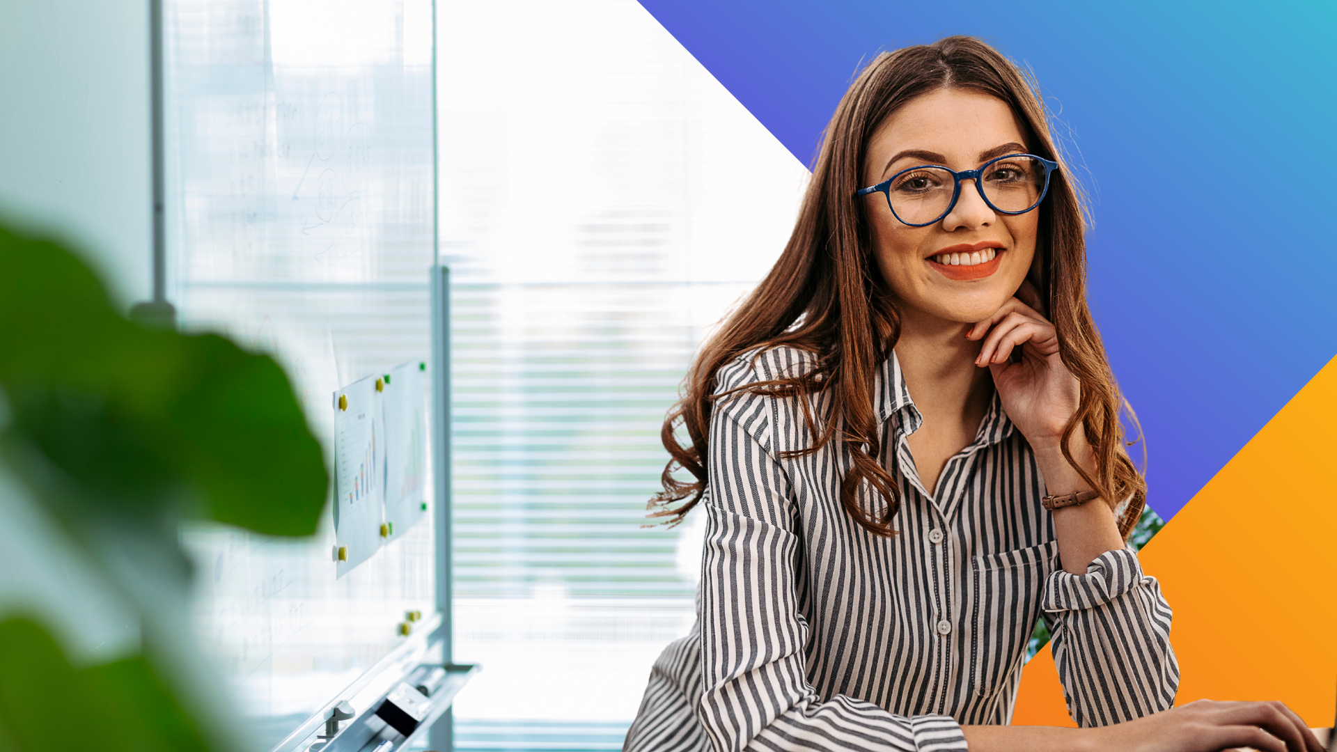 A woman with long brown hair and glasses, wearing a striped shirt, sits at a desk smiling. The background is a mix of office scenery and colorful geometric shapes in blue, white, and orange.