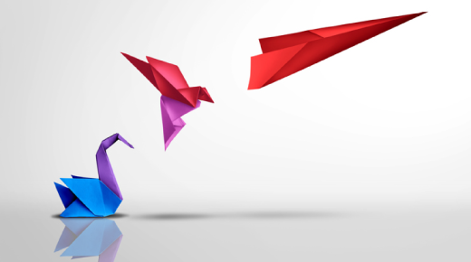 A blue and purple origami swan sits on the ground, while a pink origami bird and a red paper airplane appear to fly above it, all set against a plain light background.