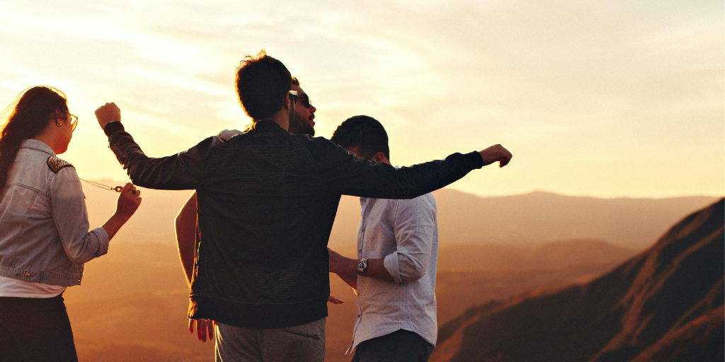 A group of men standing on a hill.