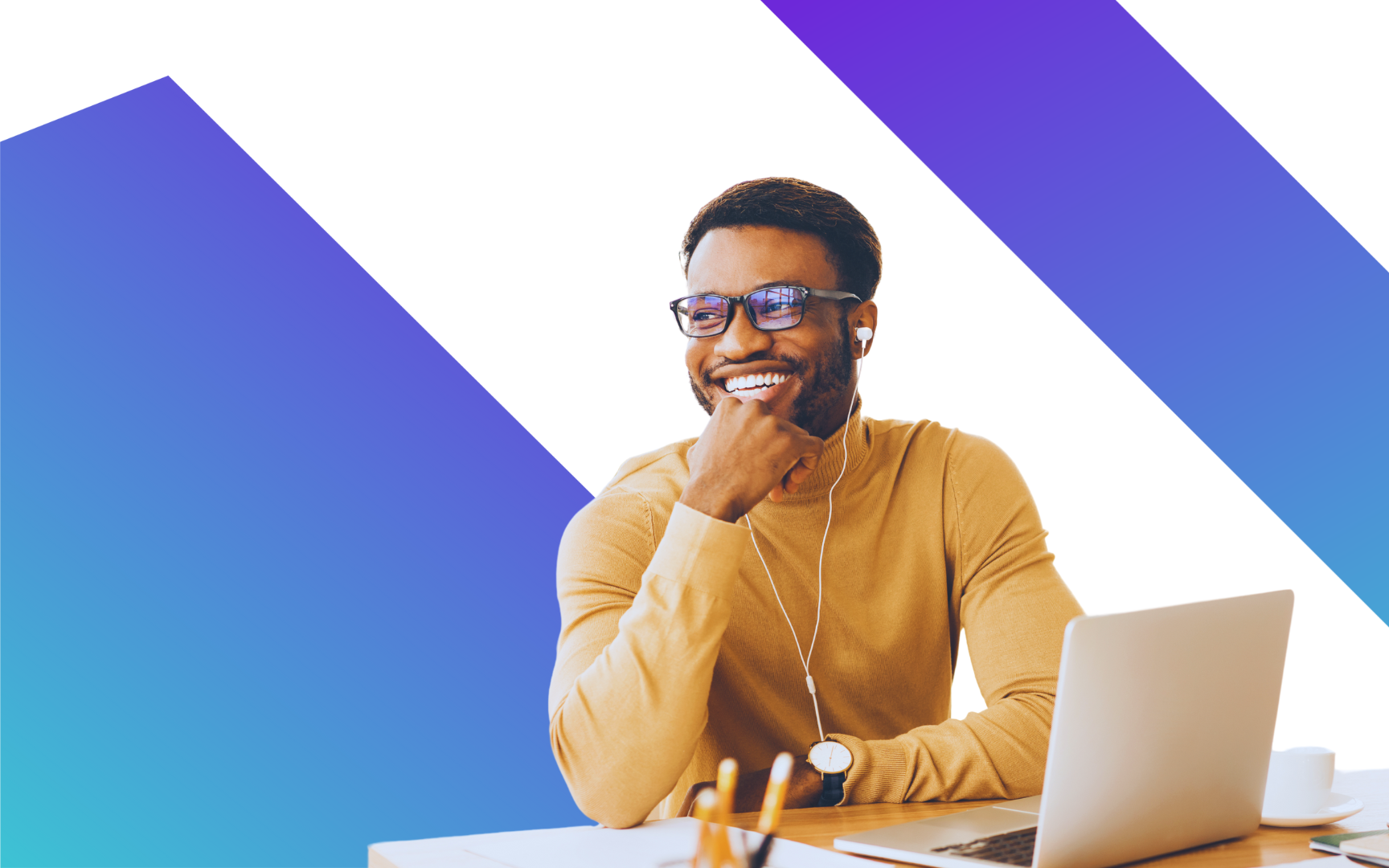 A man wearing glasses and earphones smiles while sitting at a desk with a laptop, against a white background with blue and purple diagonal stripes.