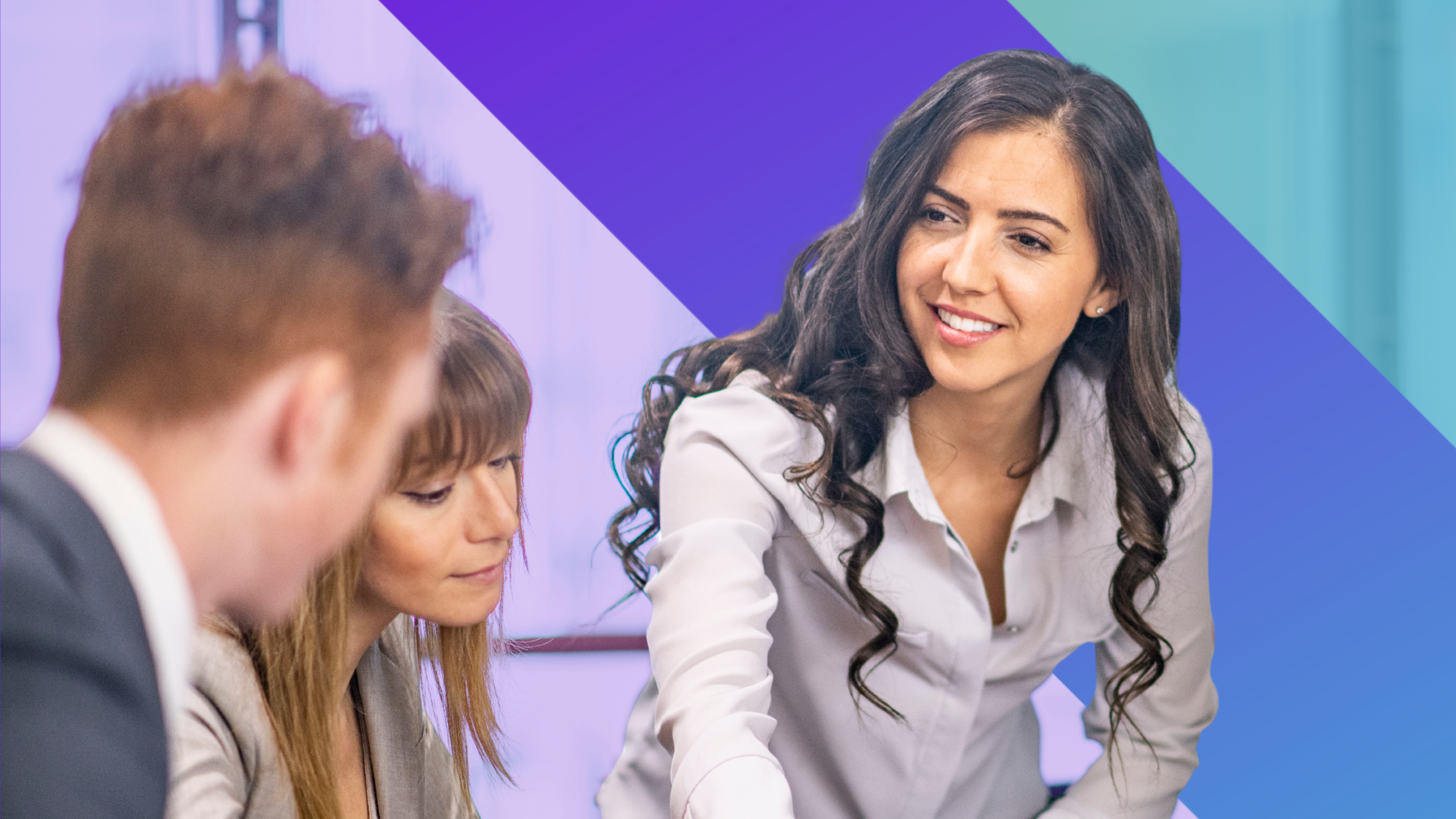 Three professionals in business attire have a discussion. A smiling woman with long dark hair gestures whilst talking to two colleagues. The background features a blue and purple geometric design.