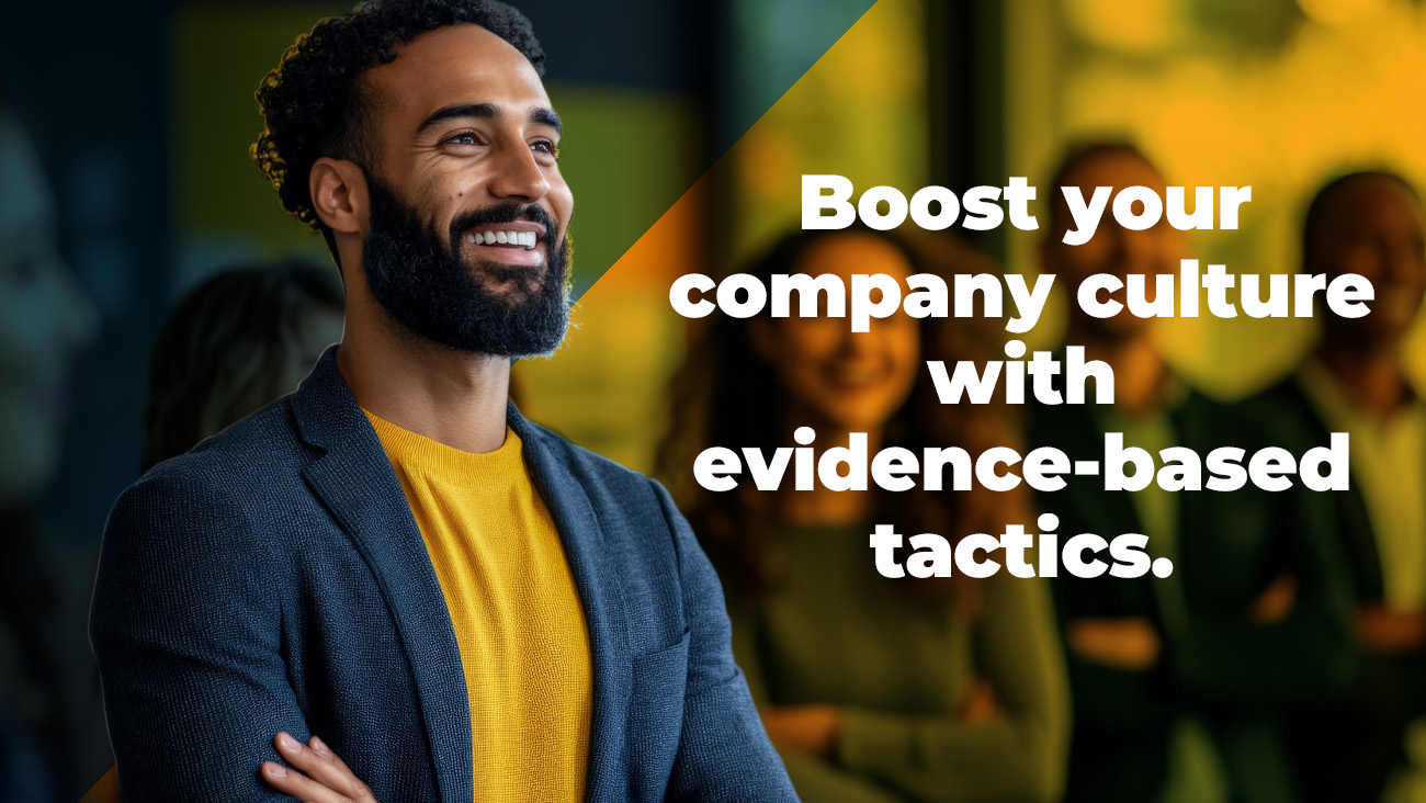 A smiling, bearded man in a blazer stands confidently with arms crossed. Behind him are blurred colleagues. Text reads: Boost your company culture with evidence-based tactics.