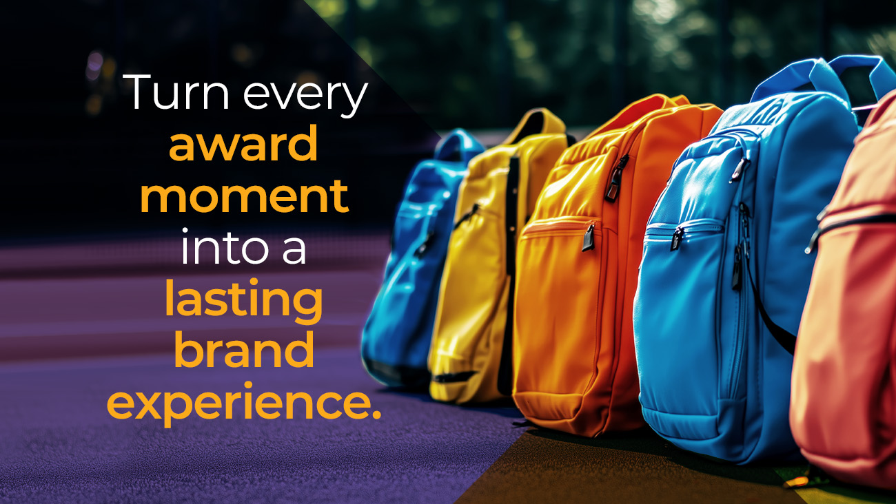 Colorful backpacks lined up on a surface outdoors with the text: Turn every award moment into a lasting brand experience. appearing on the left side of the image.