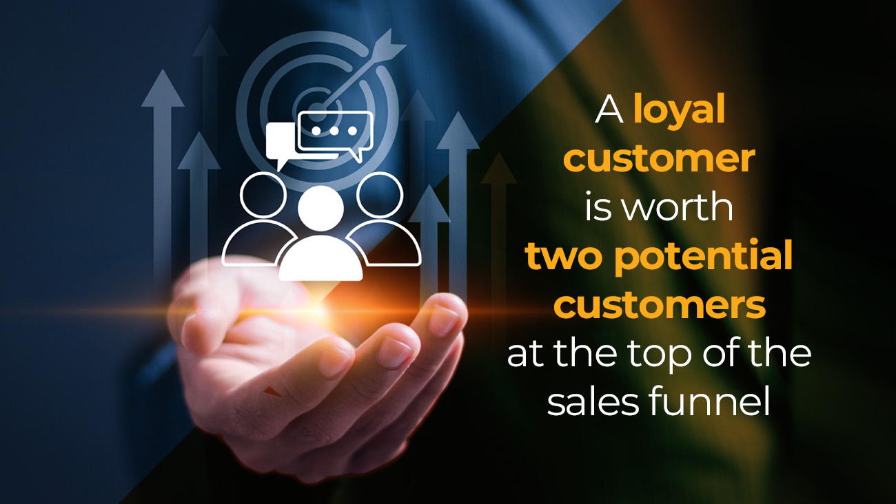 A person’s hand holds glowing icons of people, a target, and arrows. The text reads, “A loyal customer is worth two potential customers at the top of the sales funnel.”.
