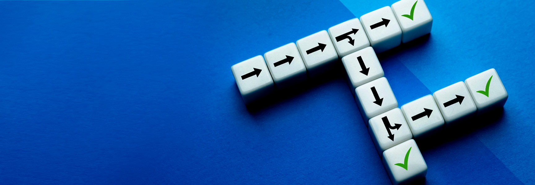 White cubes with black arrows and green check marks form a right angle on a blue background. The arrows point in different directions, while the check marks are on three of the cubes.