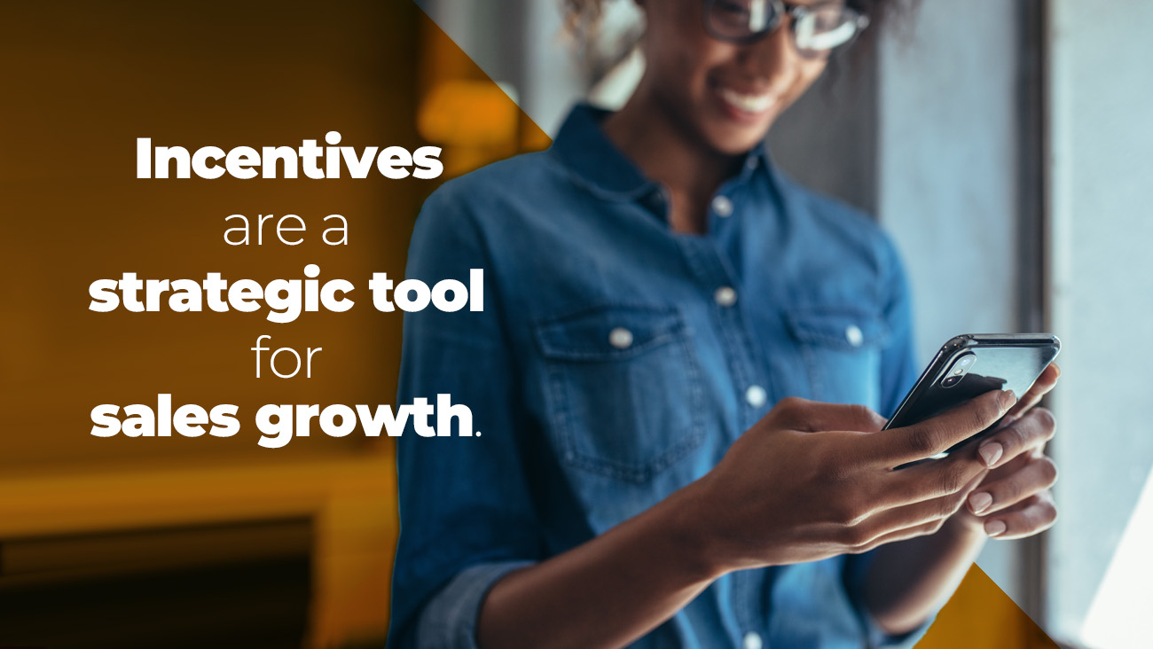 A smiling person in a denim shirt uses a smartphone, with the text Incentives are a strategic tool for sales growth displayed beside them on a blurred background.