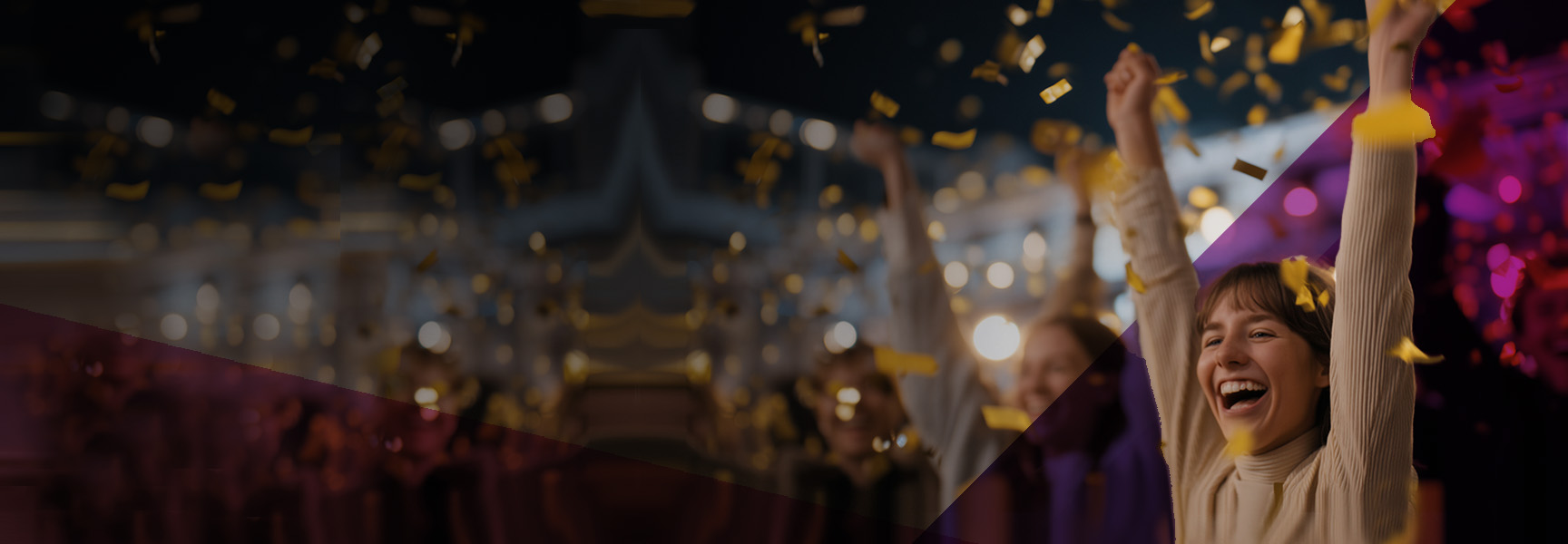 A smiling person raises their arms in celebration as gold confetti falls around them in a festive, dimly lit indoor setting.